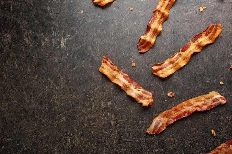 Bacon strips on dark surface