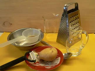 Brambor, struhadlo a nádobí na odstranění škrobu.