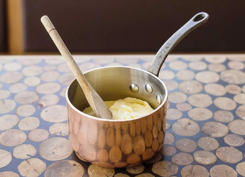 Pot with mashed potatoes and spoon