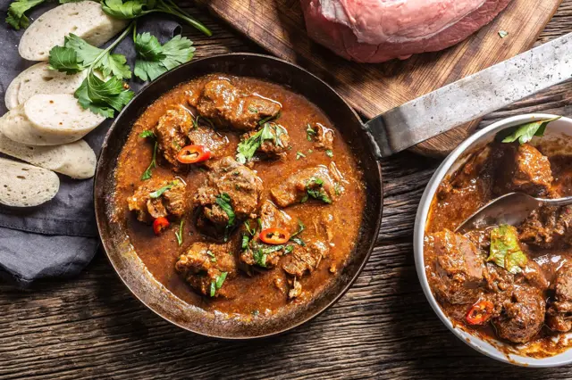 Cooked beef stew with meat chunks and herbs