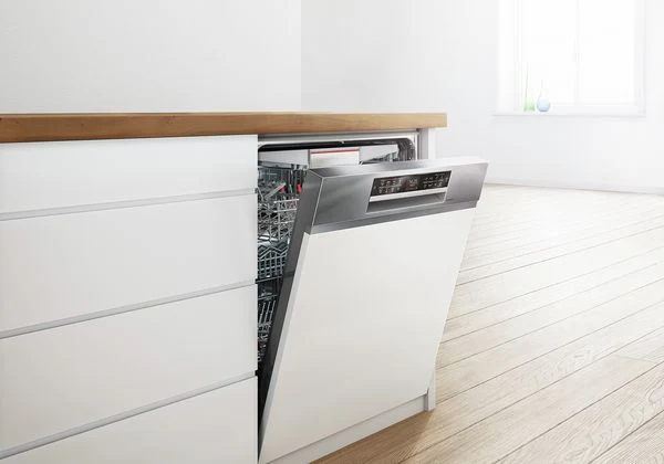 Open dishwasher in kitchen cabinet
