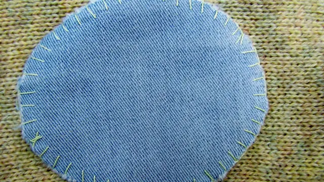 Stitched denim patch on fabric