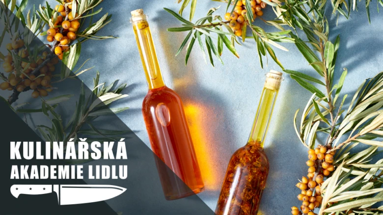 Dvě lahvičky s rakytníkem obklopené větvemi plody.