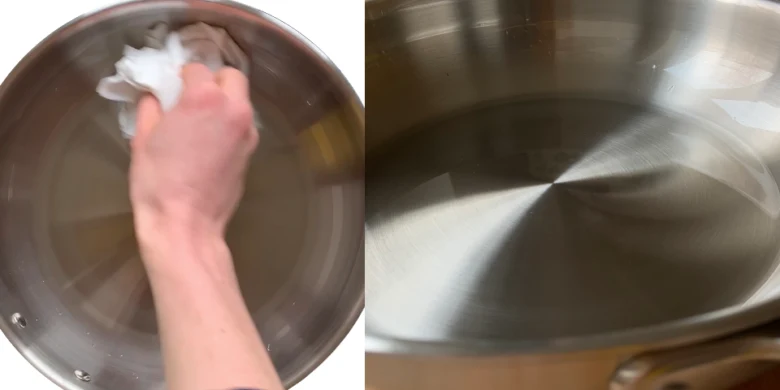 Ruka otírá vnitřek pánevně hadříkem před prvním použitím.