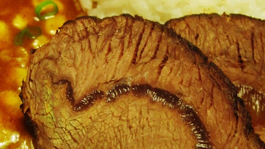 Sliced roast beef with gravy and rice