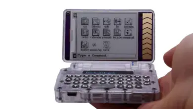 Transparent mobilní telefon s ikonami aplikací na displeji.