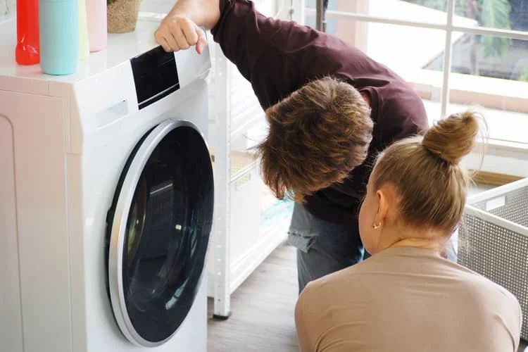 People inspecting washing machine
