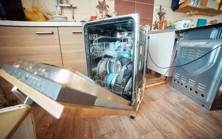 Dishwasher with open door and dishes inside